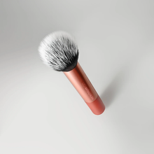 Load image into Gallery viewer, Close-up product image of the Real Techniques RT271 Skin Tint Base Brush with a rose gold handle and fluffy dual-fiber bristles against a soft neutral background.
