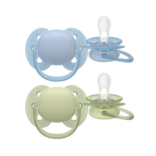 Load image into Gallery viewer, A set of two Philips Avent Ultra Soft pacifiers in beige and pink, displayed against a black background.

