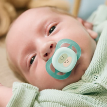 Load image into Gallery viewer, A close-up of a baby wearing a light green Philips Avent Ultra Air pacifier with a decorative character design and large ventilation holes.
