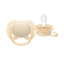 Load image into Gallery viewer, A studio shot of a beige baby pacifier, showing both the front shield and the clear silicone nipple.
