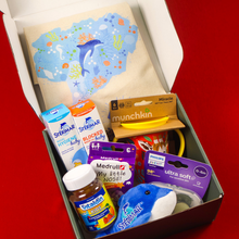 Load image into Gallery viewer, An open Botika baby subscription box packed with a canvas tote bag, Sterimar nasal sprays, Philips Avent pacifiers, Medrull My Little Nose patches, and Vitalids Kids vitamins.
