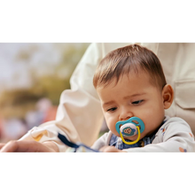 Load image into Gallery viewer, Close-up of a comfortable baby wearing the blue Philips Avent Ultra Air soother with a sheep design.
