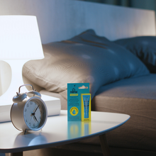 Load image into Gallery viewer, Dr. PAWPAW Lip &amp; Eye Balm 8ml in original packaging displayed on a bedside table beside an alarm clock and lamp, showcasing a daily skincare essential.
