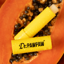 Load image into Gallery viewer, Dr.PAWPAW Original Lip Balm Stick in bright yellow packaging displayed on fresh papaya fruit, highlighting its pawpaw ingredient.
