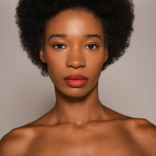 Load image into Gallery viewer, Model with deep skin tone wearing Dr.PAWPAW Tinted Ultimate Red Lip Balm
