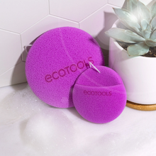 Load image into Gallery viewer, EcoTools BioBlender body cleansing sponge and facial cleansing mitt displayed next to soap suds and a potted succulent.
