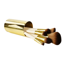 Load image into Gallery viewer, EcoTools Must Have Matte makeup brushes resting inside a metallic gold brush cup isolated on a white background.
