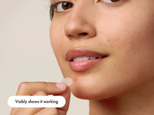 Load image into Gallery viewer, Close-up of a person applying the Hero Mighty Patch to a blemish, highlighting that the patch visibly shows it working as it draws out impurities and clears the spot overnight.
