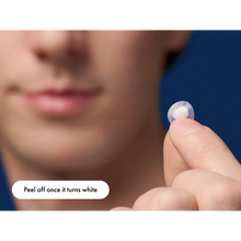 Load image into Gallery viewer, A close-up of a person holding a used, white hydrocolloid pimple patch after removal.
