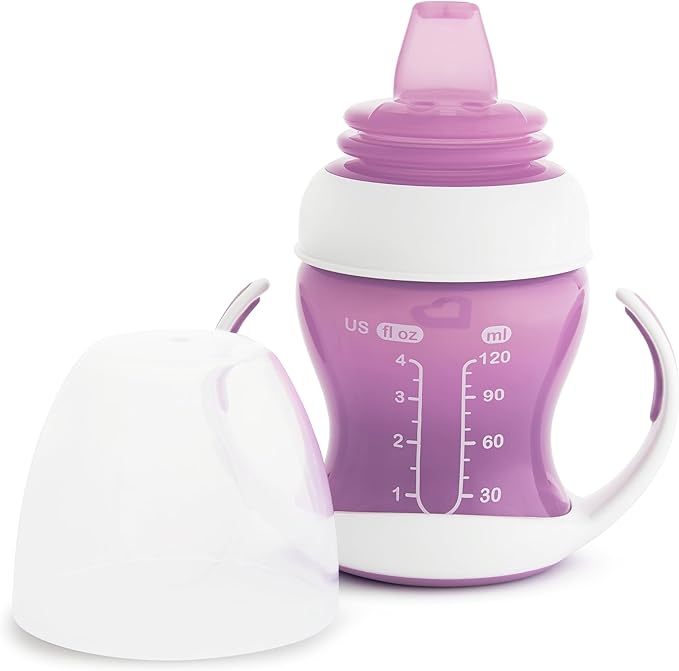 Munchkin Gentle Transition Trainer Cup, 4oz/118ml, Purple, designed for babies 4 months and older. Features a soft silicone spout gentle on gums, removable easy-grip handles, spill-proof design, and a lid for travel. BPA-free, top rack dishwasher safe, suitable for water, milk, or juice.