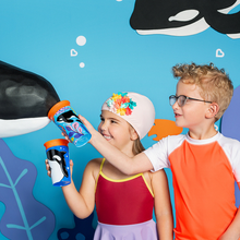 Load image into Gallery viewer, Two children holding Munchkin Miracle 360 WildLove Trainer Cups with playful animal prints.
