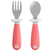 Load image into Gallery viewer, Munchkin Raise Toddler Fork and Spoon Set in pink, featuring ergonomic handles and a built-in base that keeps utensil tips off dirty surfaces to ensure a hygienic feeding experience.
