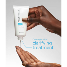 Load image into Gallery viewer, A lifestyle image of a person dispensing clear gel from the white NeoStrata Clarify Exfoliating Mask tube into their palm. Blue text to the right describes the product as an "Overnight skin clarifying treatment."
