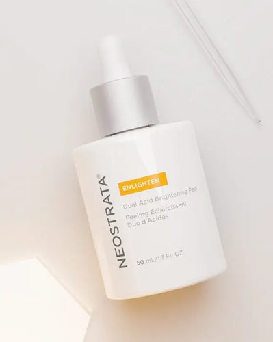 Neostrata ENLIGHTEN Dual Acid Brightening Peel serum bottle in a bright setting.
