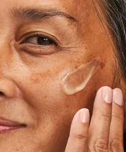 Load image into Gallery viewer, Close-up of NeoStrata Hyaluronic Luminous Lift being applied to the skin, showing the light-reflecting texture of the serum designed to deliver instant hydration and a luminous glow.
