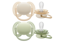 Load image into Gallery viewer, A set of four silicone baby pacifiers in neutral colours: two beige and two sage green, designed for comfortable infant soothing.
