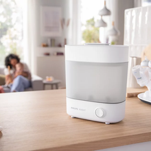 Load image into Gallery viewer, Philips Avent Advanced Electric Steam Steriliser with baby bottles in a home kitchen

