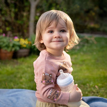 Load image into Gallery viewer, Young child holding a Philips Avent Natural Response Baby Bottle 330ml outdoors
