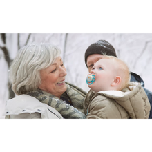 Load image into Gallery viewer, A person holding a child wearing a winter coat and using a blue tiger-themed Philips Avent Ultra Air Nighttime soother (SCF376/32) outdoors in the snow.
