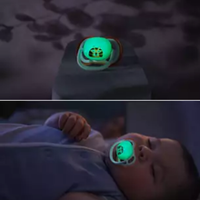 Load image into Gallery viewer, A split-screen image showing a tiger-design Philips Avent Ultra Air Night Time soother glowing in the dark and a baby sleeping comfortably with the glowing soother.
