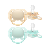 A 2-pack of Philips Avent Ultra Soft soothers for 0-6m infants in neutral mint green and light orange, featuring flexible shields for sensitive skin.