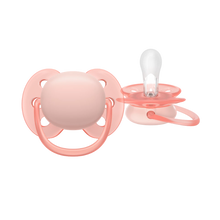 Load image into Gallery viewer, A studio shot of a pink baby pacifier, showing both the front shield and the clear silicone nipple.
