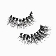 Load image into Gallery viewer, Close-up of REEM lashes showing long, wispy strands and soft curl for natural glam.
