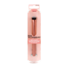 Load image into Gallery viewer, Front view of the Real Techniques Expert Concealer Brush in its official pink retail blister packaging.
