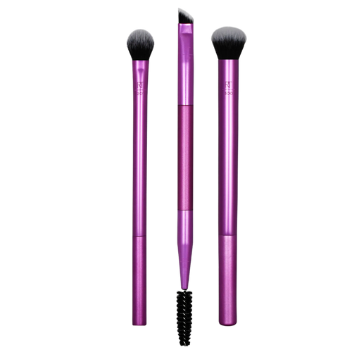 Real Techniques Eye Shade + Blend 3-piece set cutout, featuring a shading brush, a deluxe crease brush, and a dual-ended brow/liner tool with purple handles for defining eye looks.