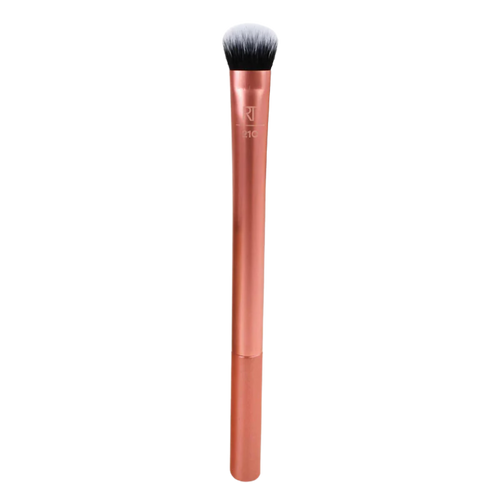 Real Techniques RT 210 Expert Concealer Brush with copper handle, featuring dense, dome-shaped bristles for blending liquid or cream concealer under the eyes and on blemishes.