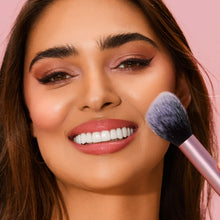 Load image into Gallery viewer, Person applying blush or powder to the cheek using the soft, tapered Real Techniques RT 400 Blush Brush for a seamless and diffused finish.
