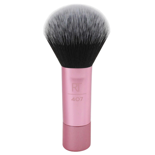 Real Techniques RT 407 Mini Multitask Brush with a short pink handle and soft, dense bristles, designed for travel and multi-purpose blending of face powders, blush, or bronzer.