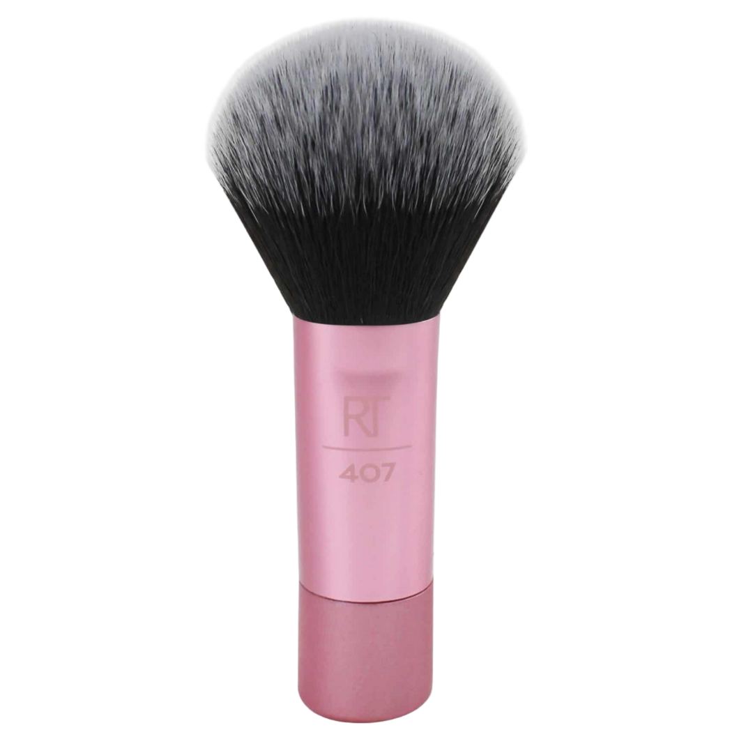 Real Techniques RT 407 Mini Multitask Brush with a short pink handle and soft, dense bristles, designed for travel and multi-purpose blending of face powders, blush, or bronzer.
