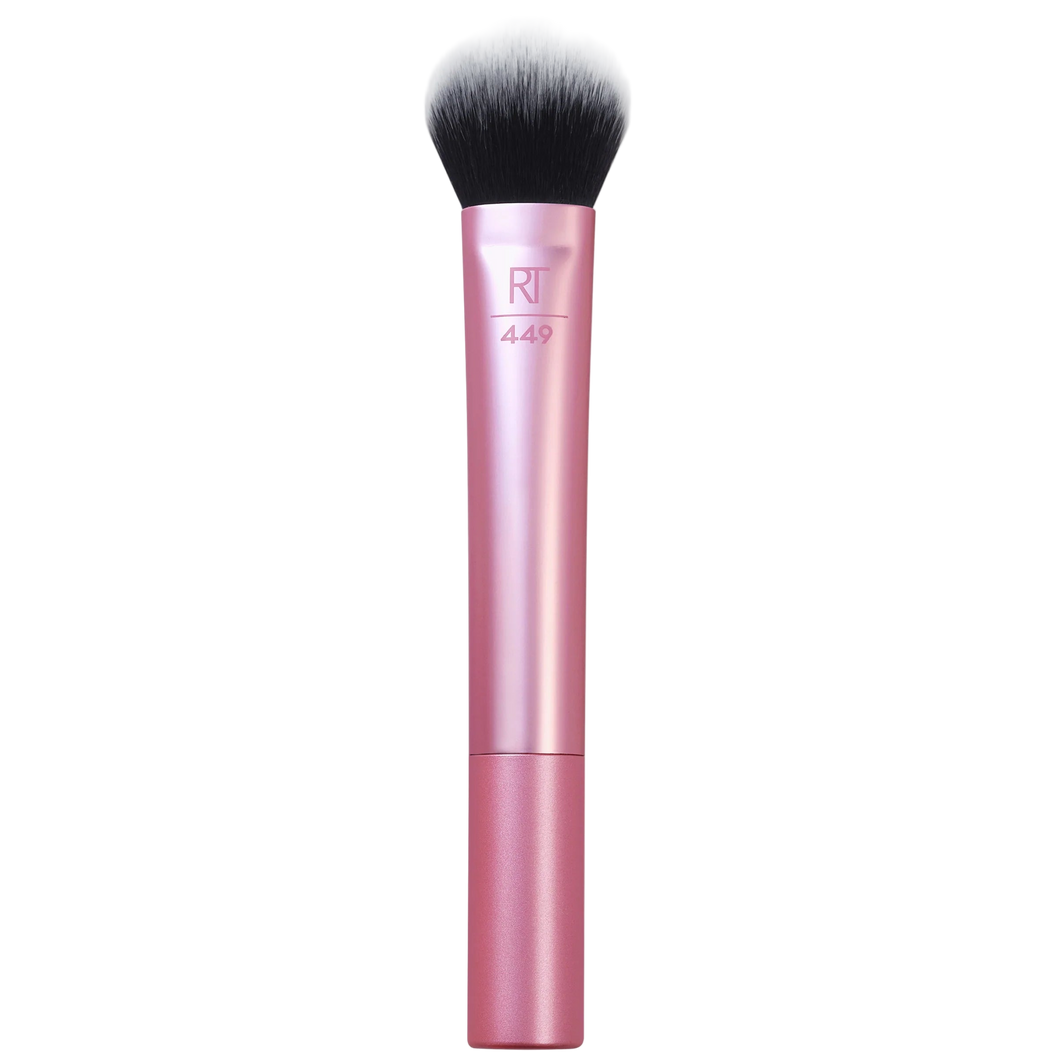 Real Techniques RT 449 Tapered Cheek Brush with a pink handle and small, dense, tapered head, ideal for controlled application of highlighter, contour, or precise blush placement.
