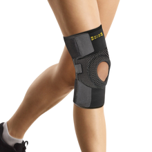 Load image into Gallery viewer, Uriel Knee Support worn on the leg, featuring breathable mesh fabric, an open patella design and adjustable straps for comfortable knee compression.
