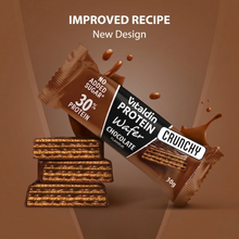 Load image into Gallery viewer, Promotional image for Vitaldin Chocolate Protein Wafer featuring the "Improved Recipe" and "New Design" text. The image shows the protein bar wrapper next to a stack of crunchy wafer slices with chocolate splashes in the background.
