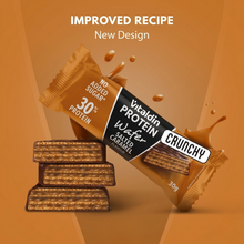 Load image into Gallery viewer, New design for Vitaldin Salted Caramel Protein Wafer featuring an improved recipe, 30% protein, and no added sugar with a stack of crunchy wafer bars.

