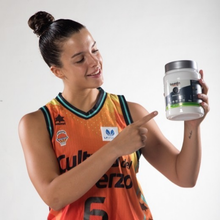 Load image into Gallery viewer, A person holding a jar of Vitaldin Sport Isotonic Hydration drink in lime flavor, showing the packaging size and branding for the 750g powdered mix.
