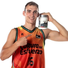 Load image into Gallery viewer, A person holding a jar of Vitaldin Sport Recovery watermelon flavor supplement against a neutral background.
