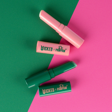 Load image into Gallery viewer, Open WICKED x Dr. PAWPAW Enchanting and Glimmer Lip Balm Sticks in green and pink twist-up packaging, showing the two different balm colours.
